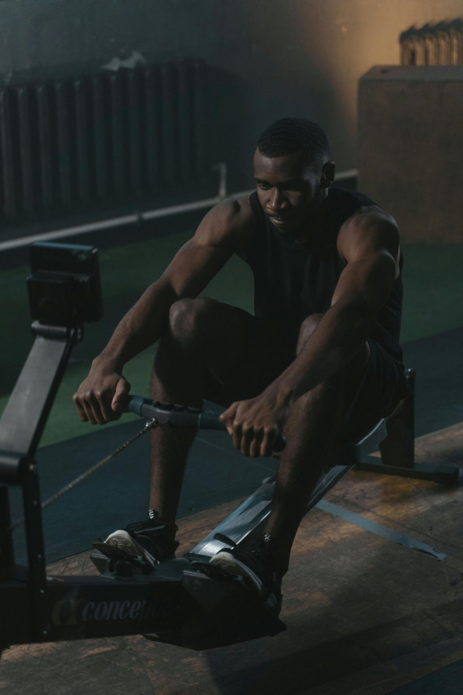 Guy sitting on gym equipment stock photo