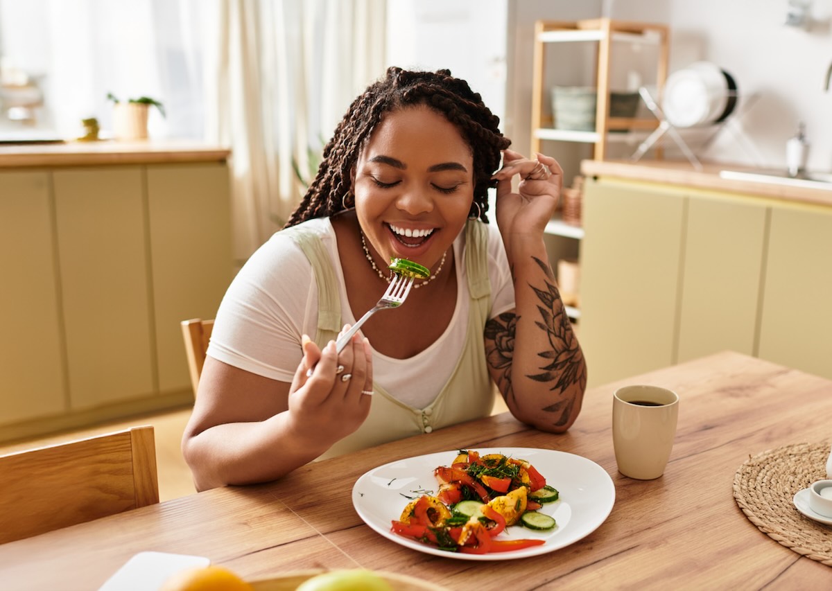 Woman enjoying a balanced meal at home, reflecting Healthy Weight Week wellness with a focus on mindful eating and overall well-being.