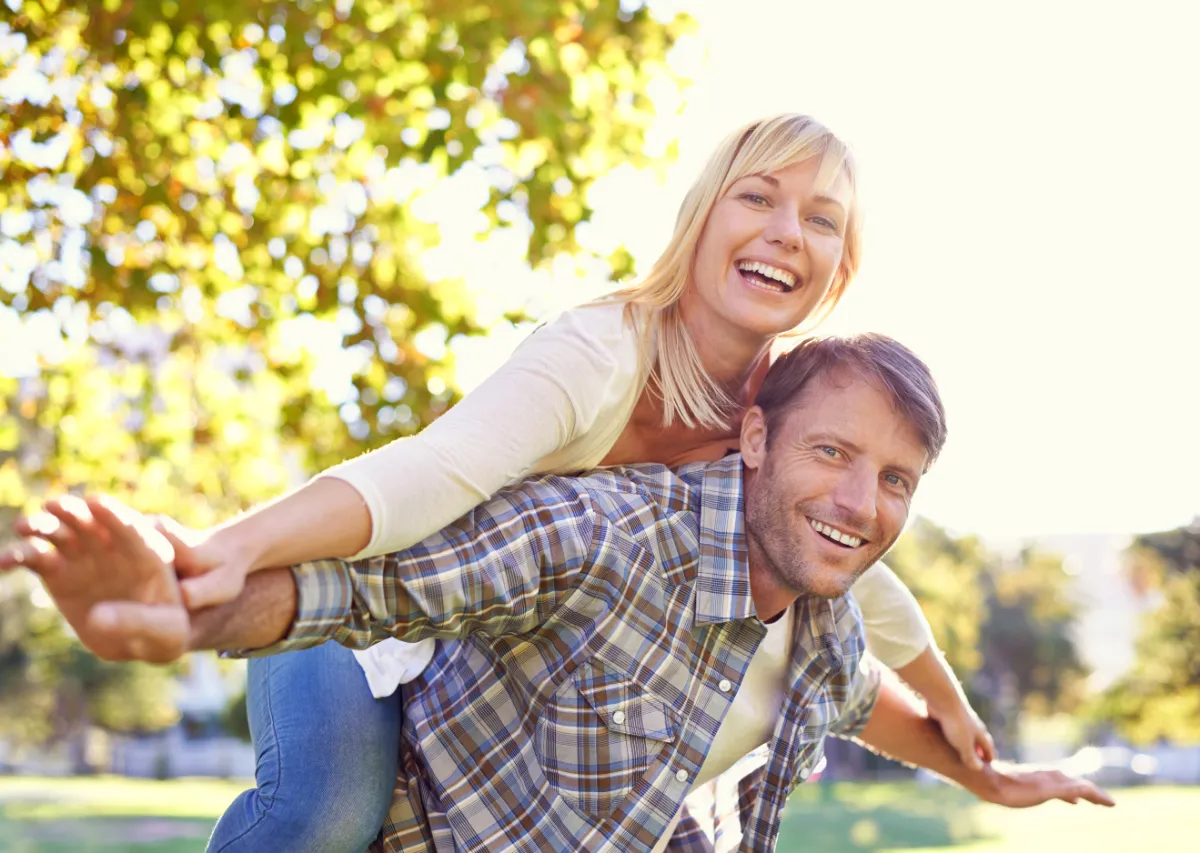 Couple enjoying a sunny spring day outdoors representing spring weight loss prep through improved energy, hormone balance, and healthy lifestyle.