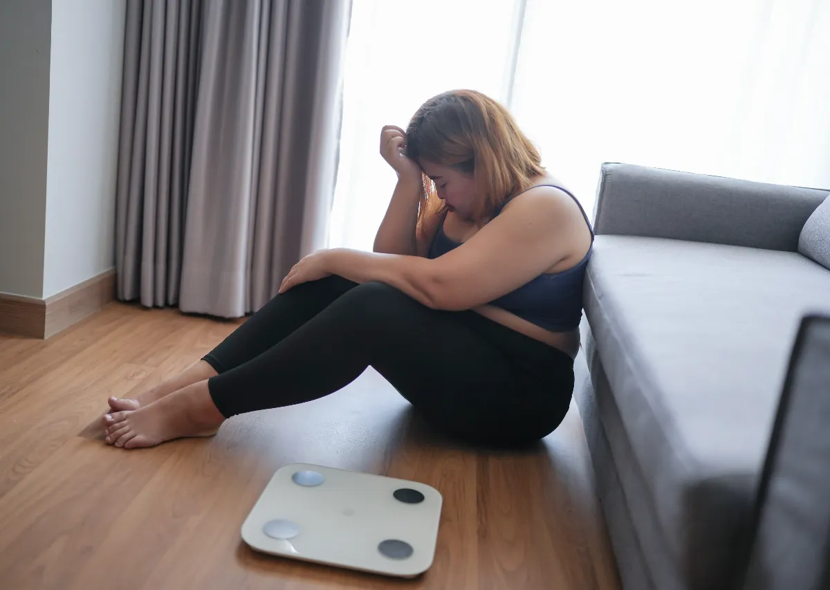 Woman feeling discouraged by weight gain while pursuing sustainable medical weight loss instead of quick diet fixes.