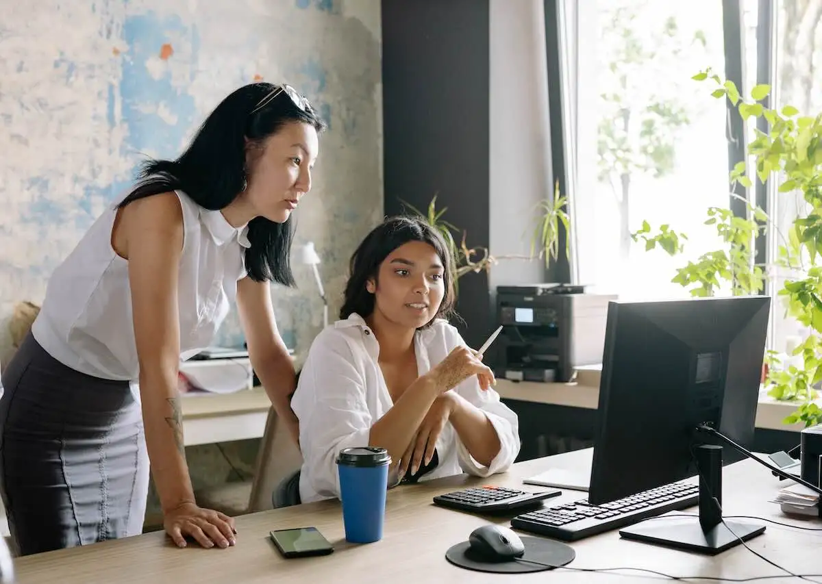 How-Hormone-Changes-Can-Affect-Womens-Health-In-Their-30s-And-40s two middle aged women in an office looking at a computer