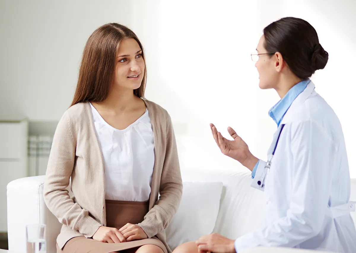 woman talking with her doctor about hormone optimization
